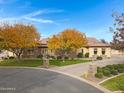 Beautiful stone and stucco house with autumn trees at 24002 S 201St Ct, Queen Creek, AZ 85142