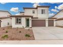 Charming two-story home with neutral colors, a three-car garage, and manicured landscaping at 4918 W Beryl Ave, Glendale, AZ 85302