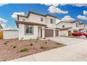 Charming two-story home with neutral colors, a three-car garage, and manicured landscaping at 4918 W Beryl Ave, Glendale, AZ 85302