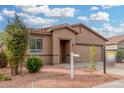 Single-story house with a two-car garage and landscaping at 6903 W Irwin Ave, Laveen, AZ 85339