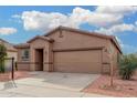 Single-story house with a two-car garage and landscaping at 6903 W Irwin Ave, Laveen, AZ 85339