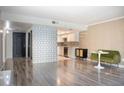 Open living room featuring wood floors, modern décor and an open concept to the kitchen at 7970 E Camelback Rd # 101, Scottsdale, AZ 85251