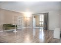 Bright living room with wood floors, modern decor, and sliding glass doors leading to a balcony at 7970 E Camelback Rd # 101, Scottsdale, AZ 85251