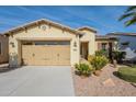 Front view of a charming house with a two-car garage and well-maintained landscaping at 1342 E Verde Blvd, Queen Creek, AZ 85140