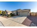 House exterior featuring a two-car garage and drought-tolerant landscaping at 18865 W Mescal St, Surprise, AZ 85388