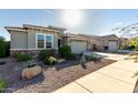 Front yard view of a one-story house with a two-car garage at 18865 W Mescal St, Surprise, AZ 85388