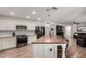 Bright kitchen featuring white cabinets, stainless steel appliances, and a large butcher block island for cooking and entertaining at 19641 E Emperor Blvd, Queen Creek, AZ 85142