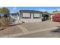 Mobile home exterior showcasing a walkway and landscaping at 201 S Greenfield Rd # 205, Mesa, AZ 85206