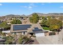 Aerial view showing house with solar panels, large backyard, and mountain views at 24444 N 40Th Ln, Glendale, AZ 85310