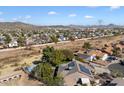 Aerial view showcasing a house with solar panels and a swimming pool, nestled in a residential area at 24444 N 40Th Ln, Glendale, AZ 85310