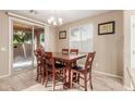 Kitchen dining area with wood table and access to backyard at 314 N 79Th Pl, Mesa, AZ 85207