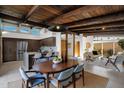 Mid-century modern dining area with wood table and chairs, adjacent to kitchen at 4216 N 38Th St # C, Phoenix, AZ 85018