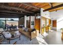 Spacious living room with mid-century modern furniture and large windows at 4216 N 38Th St # C, Phoenix, AZ 85018