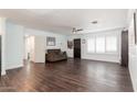 Spacious living room featuring hardwood floors, a ceiling fan, and neutral paint at 813 E Glendale Ave, Phoenix, AZ 85020