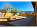 Landscaped backyard with a patio, sitting area, and mountain views at 8213 S 25Th St, Phoenix, AZ 85042