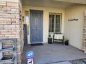 Inviting front entry with decorative door, welcome sign, and seating area at 8605 W Carole Ln, Glendale, AZ 85305