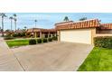 Attractive tan home with terracotta roof and a large garage at 9734 N 105Th Dr, Sun City, AZ 85351