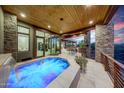 Relaxing spa with a waterfall feature adjacent to a refreshing pool at 10878 E Sundance Trl, Scottsdale, AZ 85262