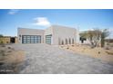 Single-story home with modern garage door and desert landscaping at 12808 E Harper Dr, Scottsdale, AZ 85255