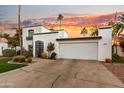 Two-story home with a white exterior and attached garage at 144 E Boca Raton Rd, Phoenix, AZ 85022