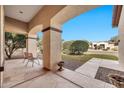 Covered porch with stone flooring, offering views of the front yard at 2415 W Weatherby Way, Chandler, AZ 85286