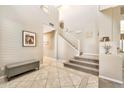 Elegant staircase with a light wood railing leading to the upper level at 2415 W Weatherby Way, Chandler, AZ 85286