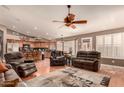 Open living room with comfortable seating, a ceiling fan, and hardwood floors at 3121 S Verde Cir, Mesa, AZ 85212