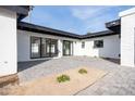 Backyard patio with pavers, and sliding glass doors leading to the interior at 342 E Orangewood Ave, Phoenix, AZ 85020