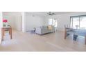 Open-concept living room featuring a dining table and a comfortable gray sofa at 342 E Orangewood Ave, Phoenix, AZ 85020