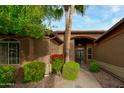 Front entry with walkway, dark door, and red flowers at 3799 N 154Th Dr, Goodyear, AZ 85395