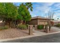 Tan house with desert landscaping and a two-car garage at 3799 N 154Th Dr, Goodyear, AZ 85395