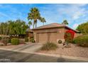 House exterior with a two-car garage and red flowering bushes at 3799 N 154Th Dr, Goodyear, AZ 85395