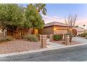 Inviting home features a landscaped front yard with a charming pathway, mature trees and desert accents at 3799 N 154Th Dr, Goodyear, AZ 85395