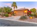 Charming home with a well-manicured yard, two-car garage, and tasteful desert landscaping, enhancing curb appeal at 3799 N 154Th Dr, Goodyear, AZ 85395