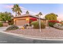 Well-maintained exterior with a two-car garage, desert landscaping, and mature trees, creating an inviting curb appeal at 3799 N 154Th Dr, Goodyear, AZ 85395