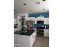 Modern kitchen featuring stainless steel appliances and a large kitchen island at 400 W Wisteria Pl, Chandler, AZ 85248