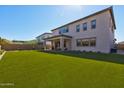 Large backyard with artificial turf and a covered patio at 7250 W Pinnacle Vista Dr, Peoria, AZ 85383