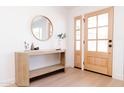 Light and bright entryway with console table and round mirror at 8437 E San Miguel Ave, Scottsdale, AZ 85250