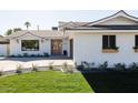 Updated midcentury modern home with a landscaped front yard at 8437 E San Miguel Ave, Scottsdale, AZ 85250