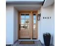 Light brown front door with glass panels and welcome mat at 8437 E San Miguel Ave, Scottsdale, AZ 85250