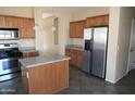 Kitchen with stainless steel refrigerator and ample wood cabinetry at 8808 W State Ave, Glendale, AZ 85305