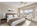 A serene main bedroom features a plush bed, neutral tones, and bright natural light from the multiple windows at 8808 W State Ave, Glendale, AZ 85305