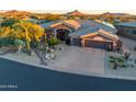 Single-story home with desert landscaping and driveway at 9771 E Roadrunner Dr, Scottsdale, AZ 85262