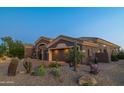 House exterior with desert landscaping and garage at 9771 E Roadrunner Dr, Scottsdale, AZ 85262