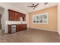 Built-in wet bar with a mini-fridge and wood cabinets at 1228 N 102Nd St, Mesa, AZ 85207