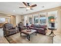 Spacious living room with leather couch and large windows at 12951 W Andrew Ln, Peoria, AZ 85383