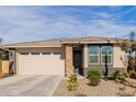 Single story home with a two-car garage, stone accents, and drought-tolerant landscaping at 19122 W Solano Dr, Litchfield Park, AZ 85340