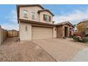 Two-story house with tan exterior, brown accents, and a landscaped yard at 19544 W Lincoln St, Buckeye, AZ 85326