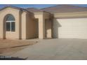 Newly built home with a two-car garage and neutral exterior at 20 W Whyman Ave, Avondale, AZ 85323