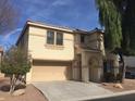 Tan two-story house with two-car garage and mature trees in front at 2636 S Sailors Way, Gilbert, AZ 85295